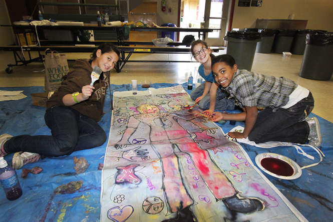 Children participating in a workshop by Kira Corser to promote nonviolent resolutions to gangs, bullying, and domestic violence, as part of First Night Monterey Artworks.